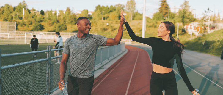 Blog of Exercise for Gut Health: How Does Exercise Affect the Gut Microbiome? which have image Two fitness friends high fiving