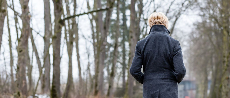 Blog of Top 5 Self-Care Tips for Seasonal Affective Disorder which have image woman outside in winter forest